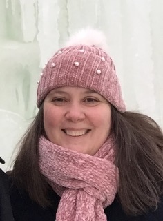 Photo of Lisa Wissert in pink scarf and hat with snow. 