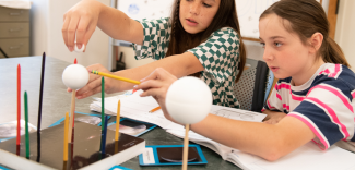 students work with moon phases model