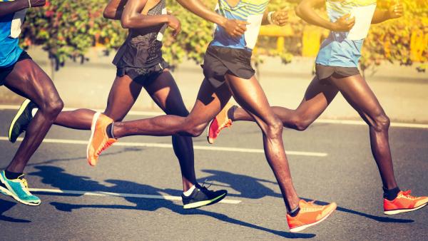 strong running legs of several marathon runners