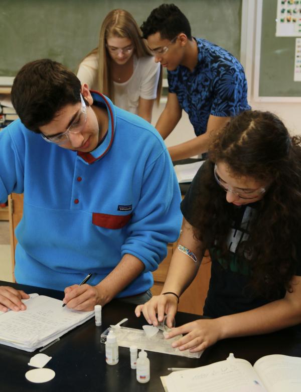 two high school students work together on a lab activity
